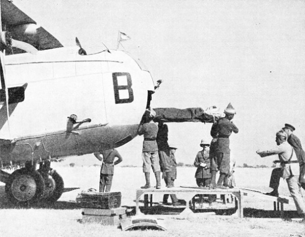 THE EVACUATION OF WOUNDED can be accomplished with aeroplane troop carriers