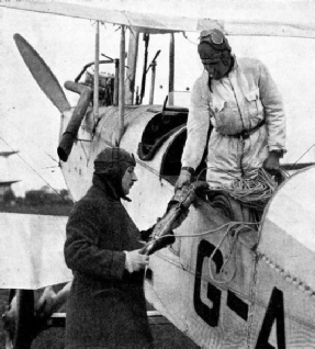 SIR ALAN COBHAM inspecting the nozzle of the petrol pipe before taking off for a test of refuelling