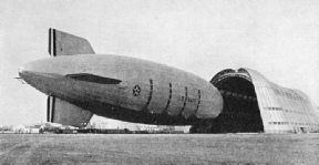 The US Navy airship Macon being towed into her shed