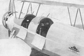 THE SIDES OF THE TWO COCKPITS in this training machine are lowered so that both control sticks are visible