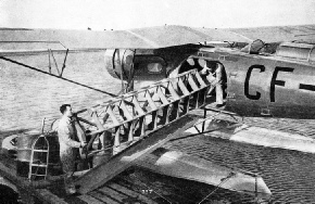 FREIGHT BEING TAKEN ABOARD A FAIRCHILD SUPER 71 MONOPLANE