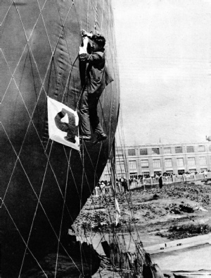 MAKING ADJUSTMENTS TO THE NET of a balloon before attaching the basket