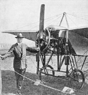 Bleriot standing beside a modern replica of one of his early monoplanes