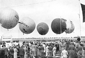 PREPARING BALLOONS FOR FLIGHT IN A HIGH WIND at an air sports meeting at Munich