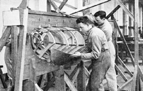 A SEAPLANE FLOAT BEING RE-COVERED by apprentices at Halton