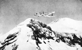 A UNITED STATES ARMY AIR CORPS MACHINE in flight above Mount Rainier