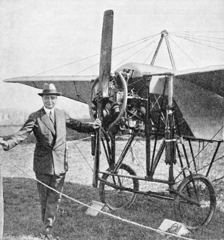 Bleriot standing beside a modern replica of one of his early monoplanes