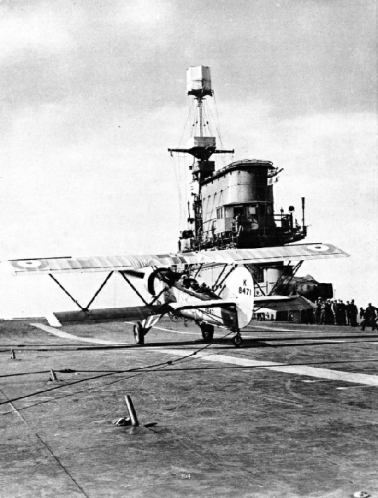 CABLES PULL UP THE AIRCRAFT after it has landed on the deck of an aircraft carrier