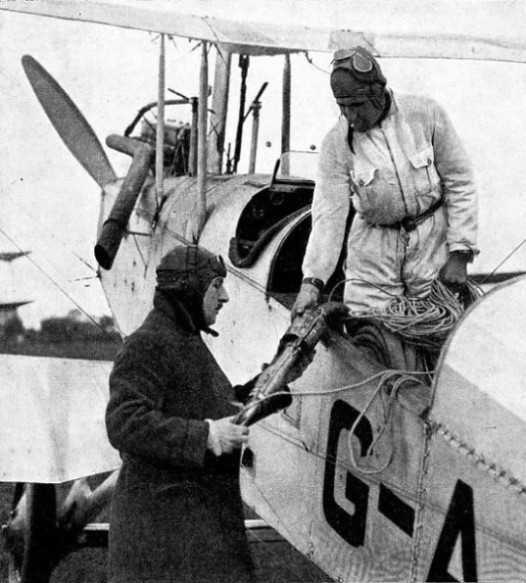 SIR ALAN COBHAM inspecting the nozzle of the petrol pipe before taking off for a test of refuelling