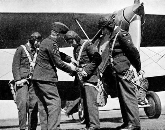 FITTING PARACHUTES on RAF apprentices before their first flight